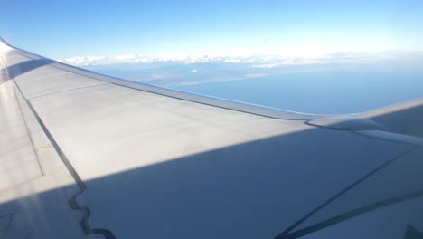 airplane flying over the clouds wing view