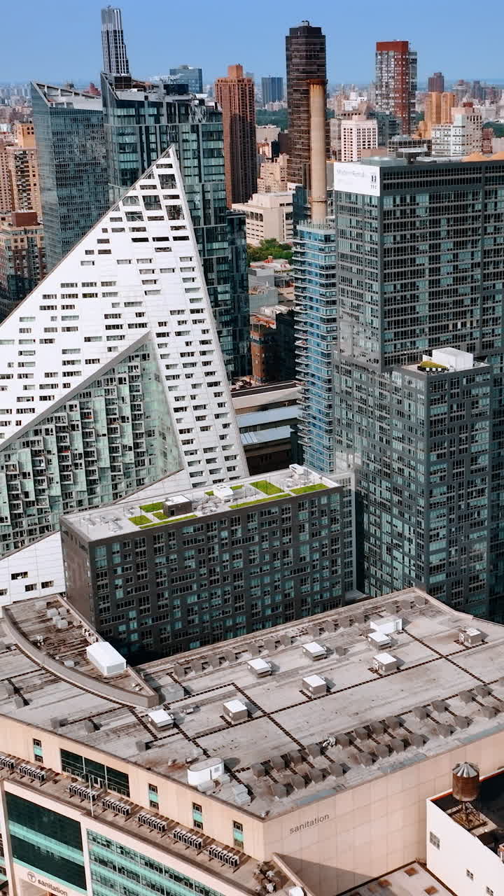 Outstanding multistoried buildings of unusual design. New York scenery on bright sunny day. Top view. Vertical video