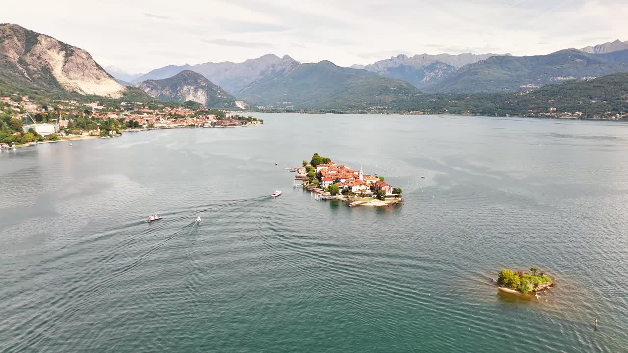 Aerial view showing Isola Bella with its baroque palace , also showing the surrounding lake, mountains, and coastal Italian towns in the distance, Stresa, VB, Piedmont, northern western Italy