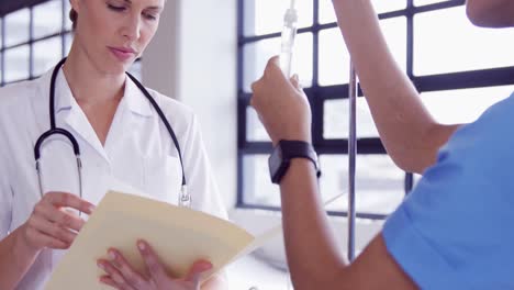 médico y enfermera examinando el goteo intravenoso
