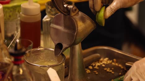 sequential lime squeezing into a glass container