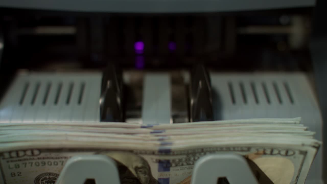 Us dollars banknotes on currency counter machine. Paper money calculation