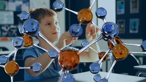 Animation-of-molecules-over-caucasian-schoolboy-in-classroom