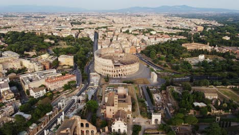 colosseum stands illuminated at sunset, surrounded by rome vast skyline, static