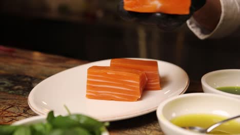 chef preparing sliced salmon
