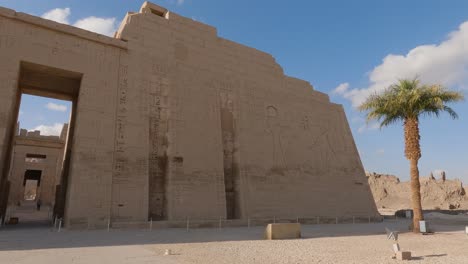 Entrance-to-Ramesses-III-temple-in-Luxor-at-Theban-Necropolis,-pan-left