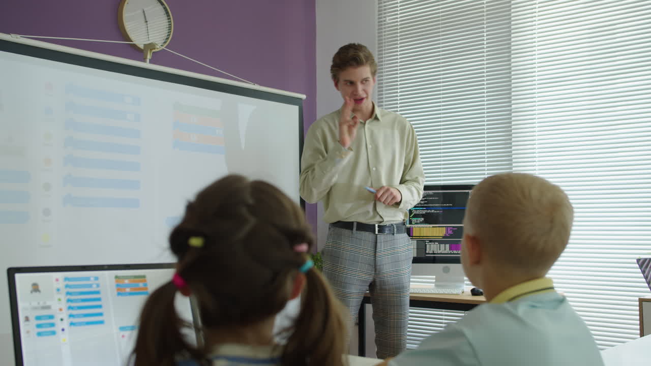 Girl Putting Hand Up to Give Answer during Group Programming Class