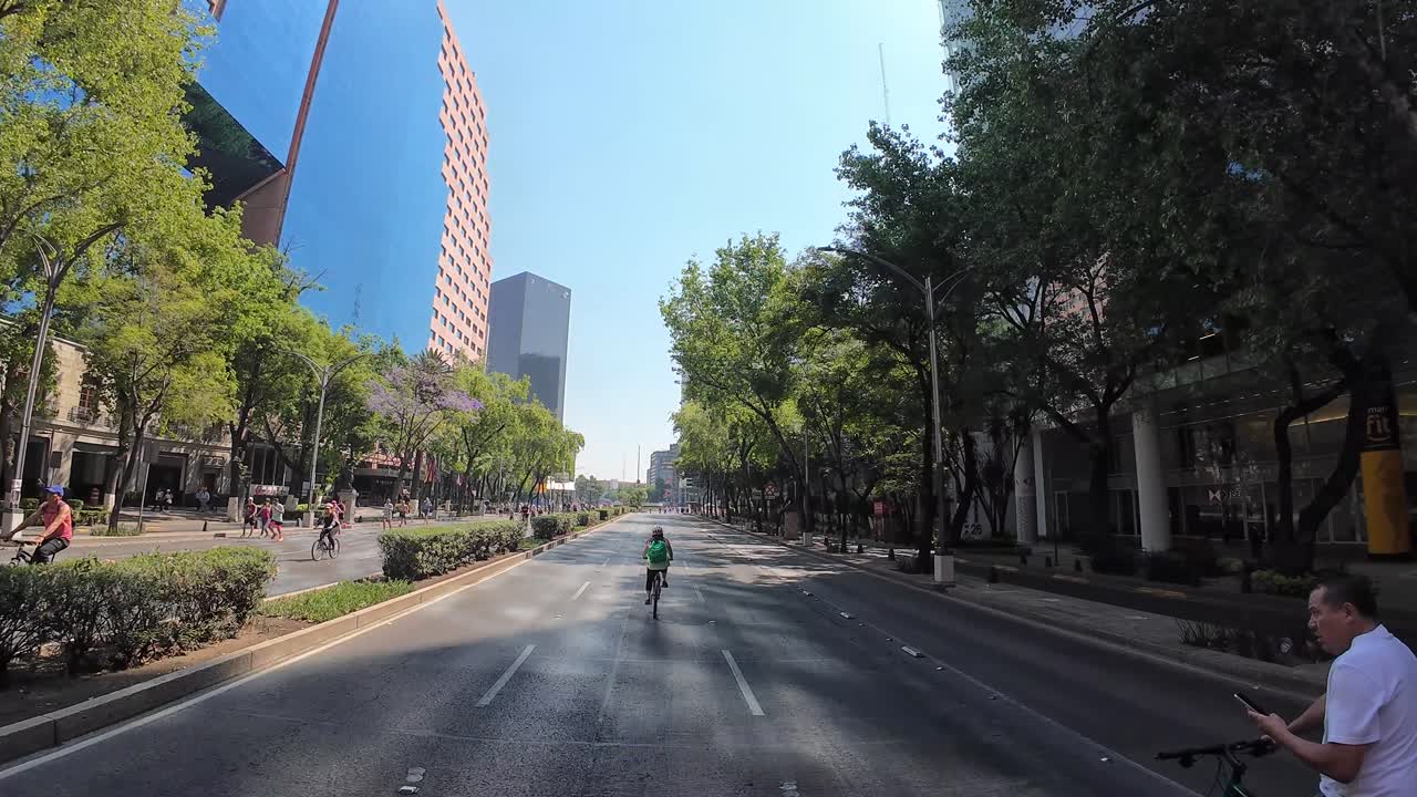 Shot of woman biker with an empty street in paseo de la reforma