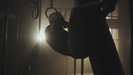person performing ring exercises in a gym