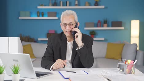 home office worker man talking on the phone happily.