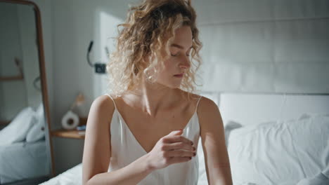 Relaxed girl massaging cream in body closeup. Closeup woman in self-care ritual