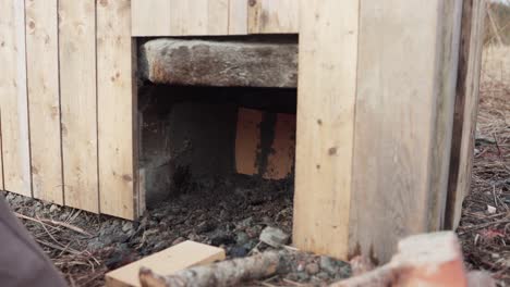 The-Man-is-Spreading-Cement-Inside-the-Stove-Situated-Beneath-the-DIY-Hot-Tub---Timelapse