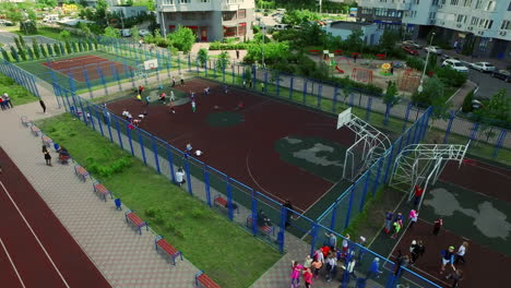 Childrens-on-basketball-court-in-yard.-Aerial-view-schoolchild-on-sportground