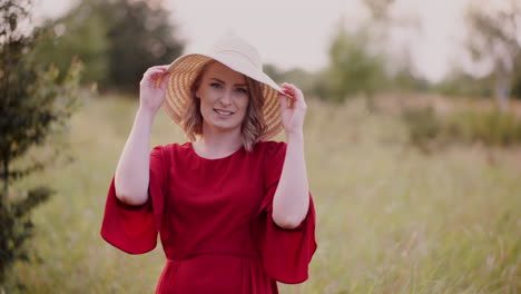 Young-Woman-Walking-On-A-Meadow-Smiling-Into-Camera-Close-Up