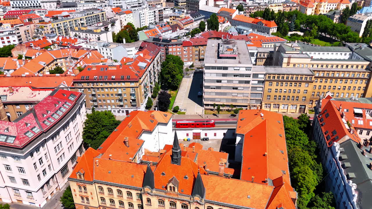 Old-fashioned historical buildings with orange roofs in the old city of Bratislava, Slovakia. Bright panorama of the urban city from drone.
