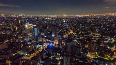 mexico city at night with independence day lights, aerial hyperlapse backward