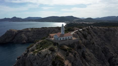 Far-de-Capdepera-Light-House-in-Mallorca-Drone-Footage-during-late-evening-sun-with-blue-ocean-in-the-background