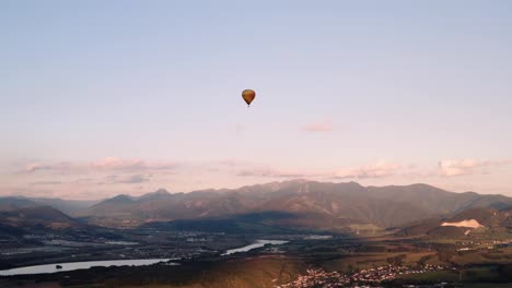 panoramic aerial view of hot air balloon floating in golden hour sky