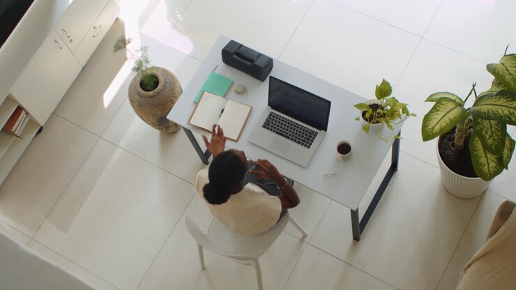 Female Office Manager Talking on Smartphone Top Down