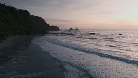 sunset over a rocky coastline beach