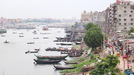 timelapse of busy buriganga river port beside urban city