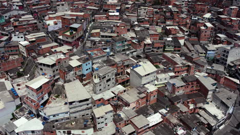 Aerial-view-of-a-poor-residential-area,-sunny-day-in-Brazil---descending,-drone-shot