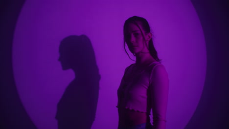 woman in purple light with shadow