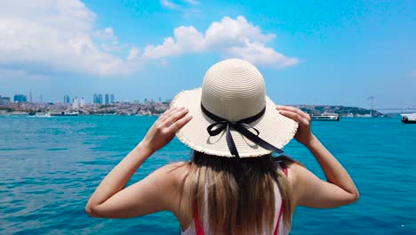 beautiful girl stands in front of bosphorus,a popular destination in istanbul,turkey