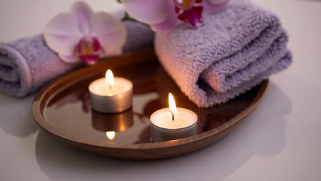 relaxing spa setting with candles and towels