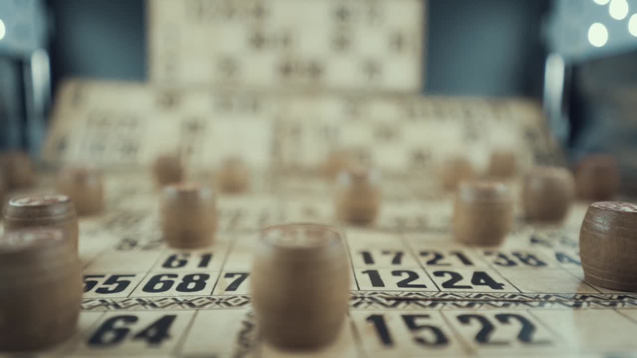 Macro video of a Bingo board, studio lights, 120 fps, slow motion, wooden chip digits, Raw footage, lottery desk game, card numbers, crane slide left smooth movement