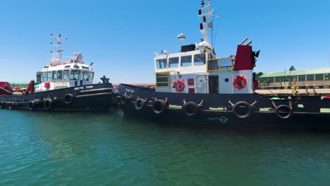 Barcos-De-Pesca-Amarrados-En-Los-Documentos,-Vista-Desde-El-Barco-Que-Sale