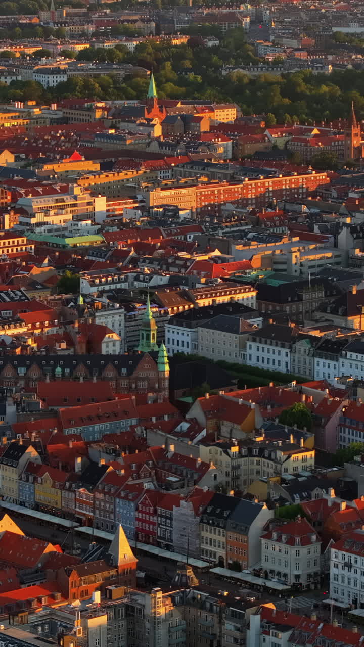 Aerial drone view of the Christiansborg Palace on the islet of Slotsholmen in central Copenhagen, Denmark at sunset. Vertical