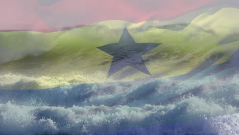 digital composition of waving ghana flag against waves in the sea