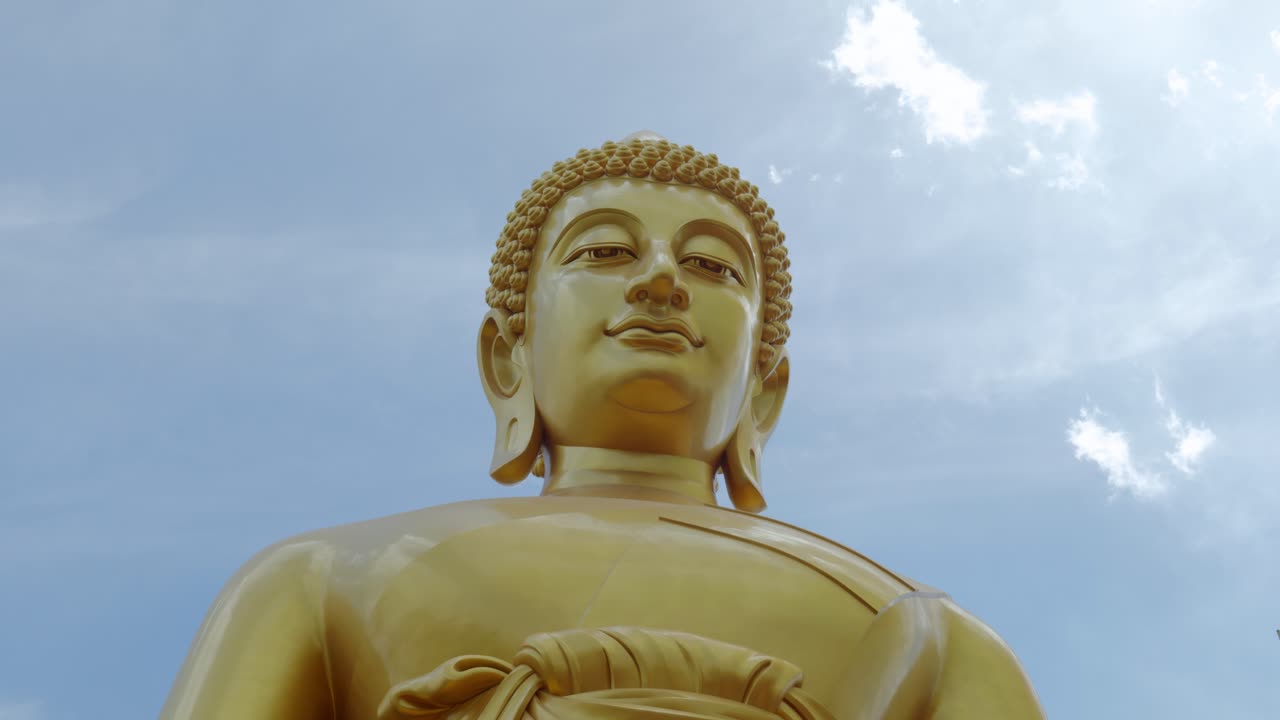 Footage of the majestic Big Buddha golden statue inside Wat Paknam Phasi Charoen Temple in Bangkok, Thailand. The video captures the intricate details of the statue and the sacred interior