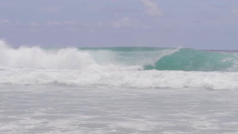 Big-Rolling-Waves-With-Surfers-At-Summertime-In-South-Gorge-Beach,-Point-Lookout,-North-Stradbroke-Island,-QLD-Australia