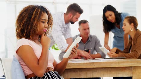 Female-executive-using-digital-tablet-in-the-office