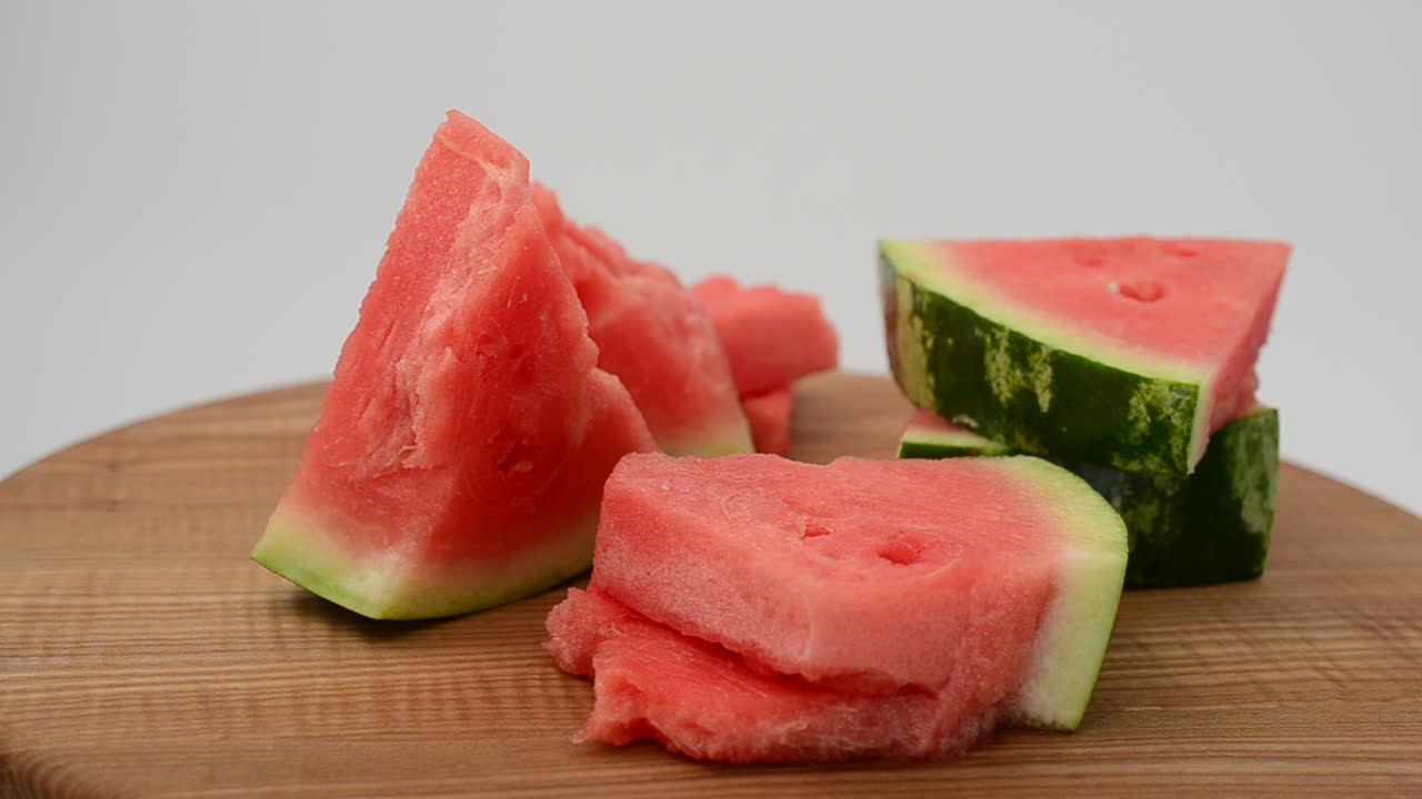 Shooting of a watermelon on a kitchen board. Shooting in the movement