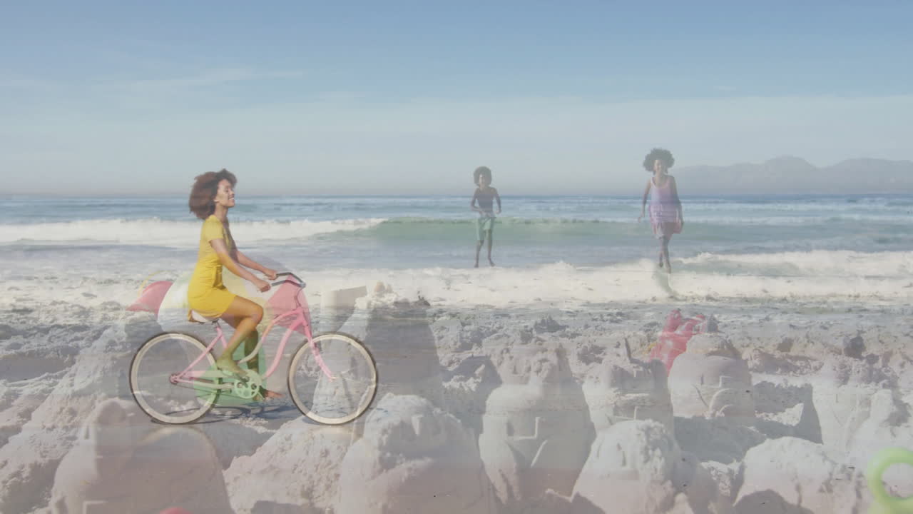 Riding bicycle on beach, woman with children playing near sandcastles in animation