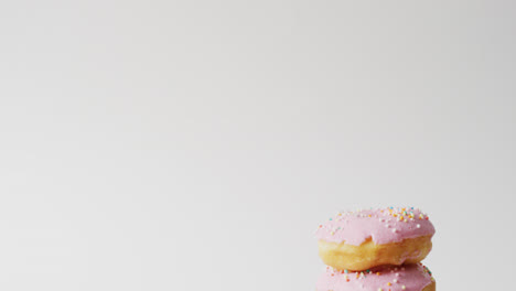 Video-of-donuts-with-icing-on-white-background