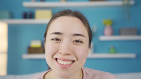 Close-up-portrait-of-positive-asian-young-woman.