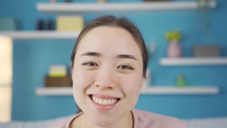 close-up portrait of positive asian young woman.