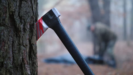 a criminal digs the body of his victim in the forest