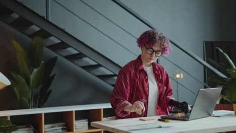 portrait of young businesswoman with prosthetic arm at office workplace