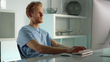 Focused-manager-surfing-web-at-workplace-closeup.-Ginger-man-checking-data.