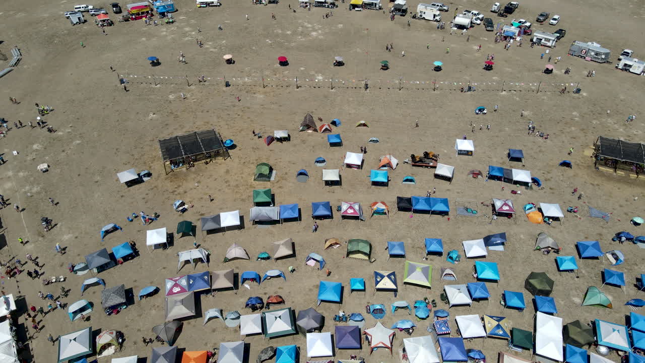 Cinematic drone flyover of patrons being entertained at a Music Festival in White Sulphur Springs, MT.