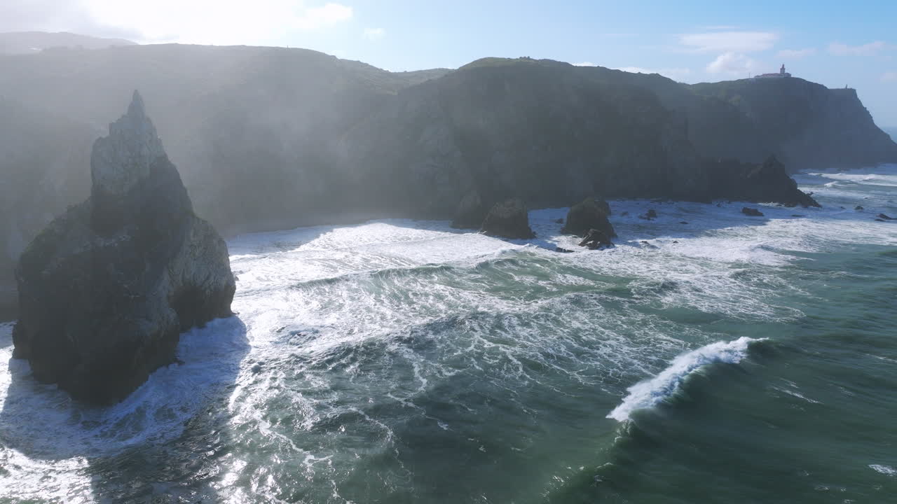 Scenic morning aerial drone shot of Praia da Ursa’s rocky cliffs near Cabo da Roca, Portugal.
