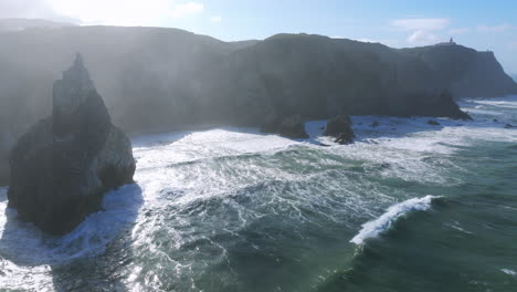 scenic morning aerial drone shot of praia da ursa’s rocky cliffs near cabo da roca, portugal.