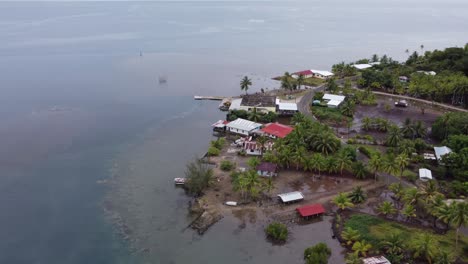 low wet shoreline village on tropical polynesian island of taha'a