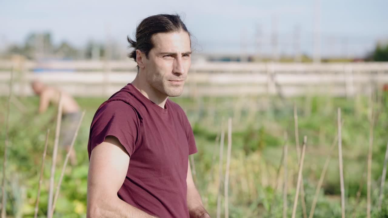 Young male farmer working in a green vegetable garden