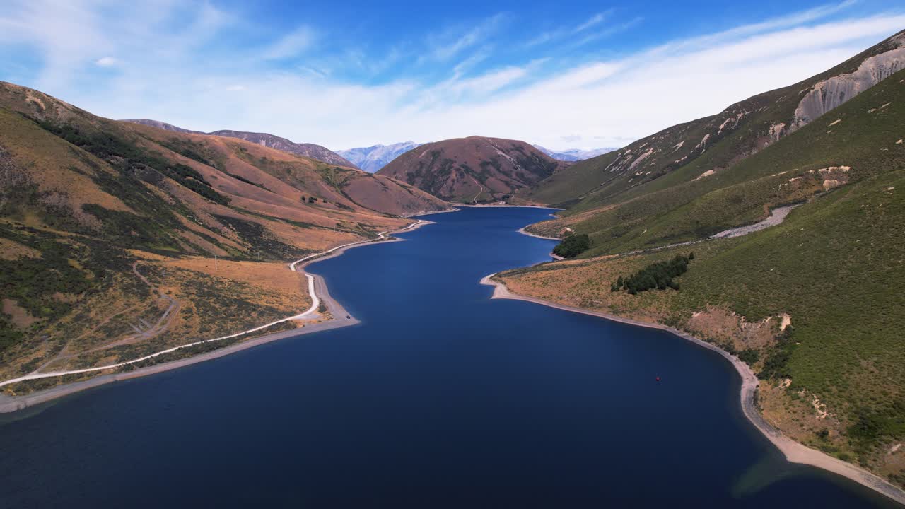 Aerial view backwards over Lake Lyndon, sunny day in Canterbury, New Zealand